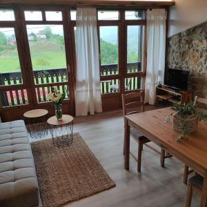 a living room with a couch and a table at El Mirador de Sorribes in Sevares