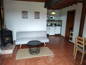 a living room with a white couch and a table at El Mirador de Sorribes in Sevares