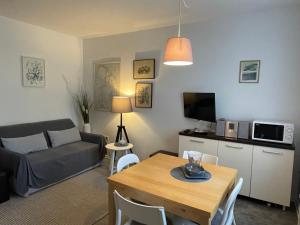 a living room with a couch and a table at Apartman Park in Dramalj