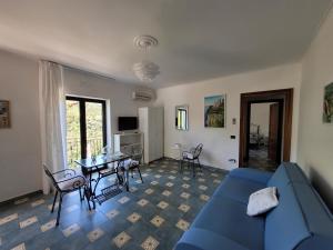 a living room with a blue couch and a table at Relais Cannavacciuolo in Vico Equense