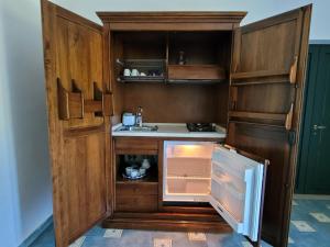 a kitchen with an open refrigerator and a sink at Relais Cannavacciuolo in Vico Equense