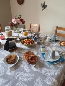 a table with plates of food on top of it at La Parenthèse in Saint-Genix-sur-Guiers
