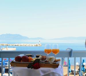 a tray of food and two glasses of beer on a table at marilena in Nea Epidavros