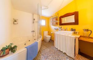 a bathroom with a tub and a sink and a toilet at Golden Summerhouse in Komiža +18 photos