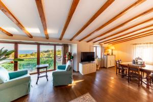 a living room with a ceiling with wooden beams at Golden Summerhouse in Komiža