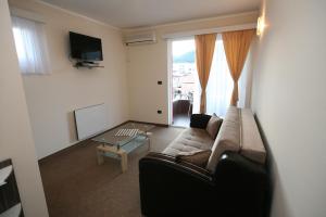 a living room with a couch and a table at VilaElenaMarko in Budva
