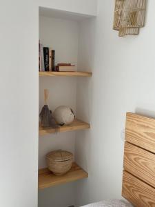 um canto de um quarto com prateleiras de madeira em Casa da Avó em Sesimbra