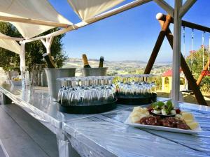 a table with wine glasses and food on it at VillaLaDiva Boutique Glamping in Massignano