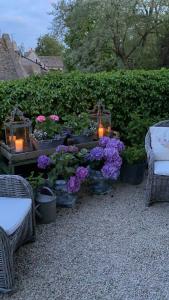 a group of plants and flowers in pots with candles at Pytts House Boutique Bed & Breakfast in Burford