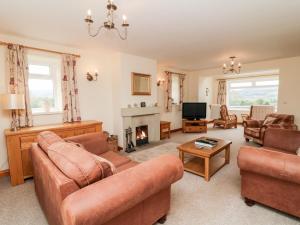 a living room with two couches and a fireplace at Jess Cottage in Skipton