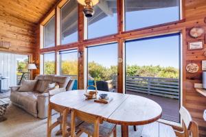 a living room with a table and a couch at Arthur's Court in Oceanside
