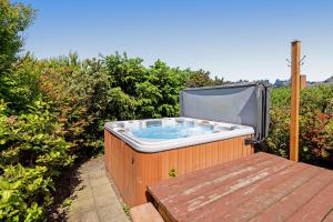 a hot tub sitting on top of a wooden deck at Arthur's Court in Oceanside