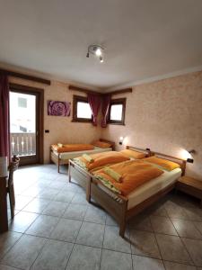 a bedroom with two beds and a balcony at Baita Stella Alpina in Livigno
