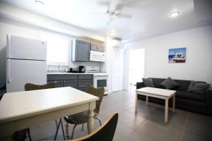 a kitchen and living room with a couch and a table at Garfield Beach House in Wildwood