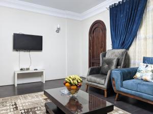 a living room with a couch and a chair and a table at Nasr city villa in Cairo