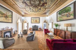 a living room with a coffered ceiling and a living room with couches at Dona Amélia in Abrantes