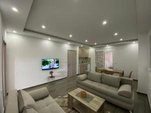 a living room with a couch and a table at Gjoni Apartments in Ulcinj
