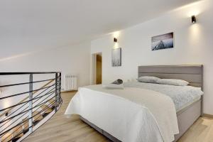 a white bedroom with a large bed in it at Apartments Sunset in Vodnjan