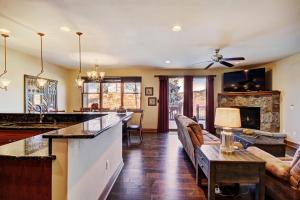 a kitchen and living room with a bar and a couch at Highland Greens 93 Apartment in Breckenridge