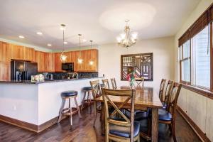 a kitchen with a dining room table and chairs at Highland Greens 93 Apartment in Breckenridge