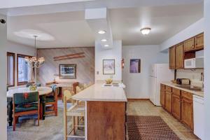 a kitchen and dining room with a table and a counter top at Park Place 104B in Breckenridge