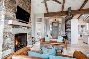 a living room with a stone fireplace and a couch at Sunrise Ski Haus in Breckenridge