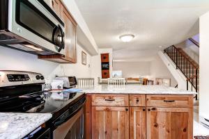 a kitchen with a stove and a microwave at Winter Point 22 in Breckenridge