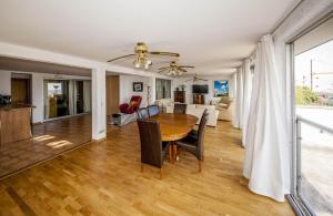 a dining room and living room with a table and chairs at Paris Belvedere With Panoramic View On Paris And Eiffel Tower in Suresnes