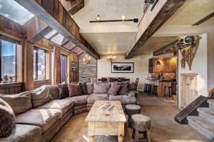 a living room with a couch and a table at Beaver Run Resort - Peak 9 Penthouse in Breckenridge