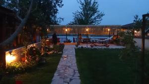 a backyard at night with a person walking in the yard at Dalyan Pension in Dalyan
