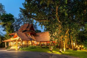 
a house with trees and a tree house at Yaang Come Village Hotel - SHA Extra Plus in Chiang Mai
