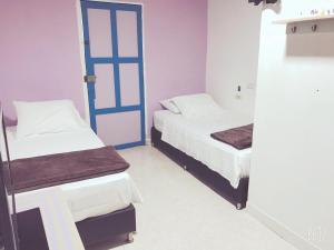 Postel nebo postele na pokoji v ubytování Hospedaje Casa Rosa Jardín