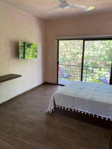 Postel nebo postele na pokoji v ubytování Hotelito YUM KAAX