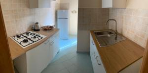 a kitchen with a stove and a white refrigerator at Brezza Marina in Massa Lubrense