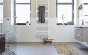 a bathroom with white walls and a glass shower at Haus Ostsee in Göhren