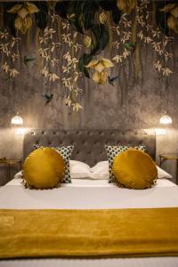 a bedroom with a bed with yellow pillows at La Terrazza Antica Dimora in Campobasso