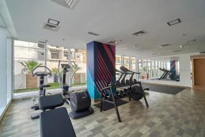 a gym with treadmills and exercise equipment in a building at Stella Stays Beautiful Studio Dubai JVC Large Terrace in Dubai