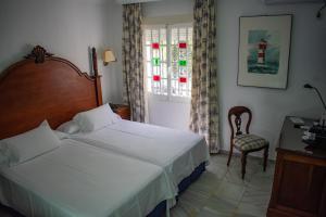 Postel nebo postele na pokoji v ubytování Hotel Playa de Regla