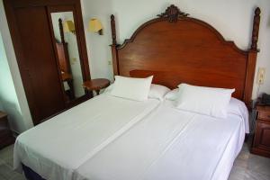 Postel nebo postele na pokoji v ubytování Hotel Playa de Regla