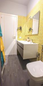 a bathroom with a sink and a toilet and a mirror at Casa Sunrise - Lovely sea front apartment in Sciacca