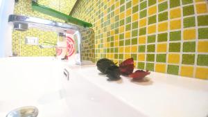 a bathroom with two butterflies sitting on a sink at Casa Sunrise - Lovely sea front apartment in Sciacca +21 photos