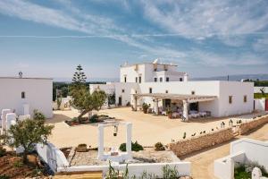 an aerial view of a large white building at Masseria Calderisi in Savelletri di Fasano