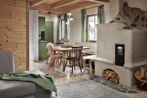 a living room with a table and a fireplace at Das Dorf in der Stadt in Schladming