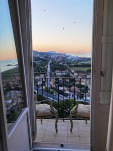a room with a view of the ocean from a balcony at La Casa Di Torre Di Palme in Marina Palmense
