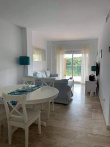 a living room with a couch and a table at Appartement Paraiso Riviera del Sol-Mijas in Málaga