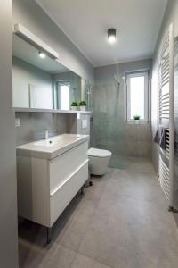 a bathroom with a white sink and a toilet at Apartament Liliowa 4 z tarasem in Kudowa-Zdrój