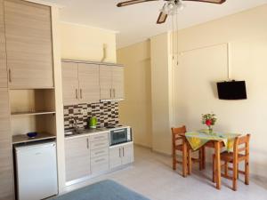 a kitchen and dining room with a table and chairs at Panagiotis I & II Stds and Apts in Tsilivi