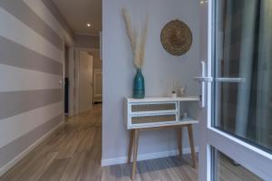 a hallway with a table and a window at Aquamarina in La Spezia