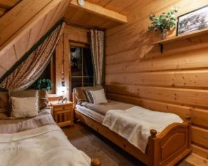 Postel nebo postele na pokoji v ubytování Domki Pod Reglami