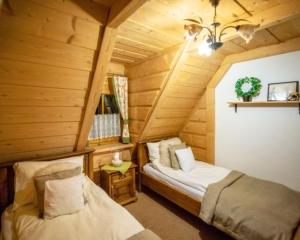 Postel nebo postele na pokoji v ubytování Domki Pod Reglami